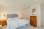 This cozy bedroom features a comfortable bed with a stylish headboard and a beautiful bedspread.