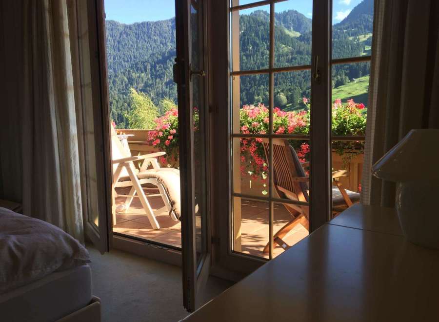 Enjoy breathtaking mountain views from this charming balcony.