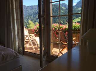 Enjoy breathtaking mountain views from this charming balcony.