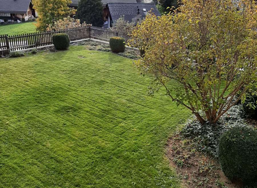 Enjoy the tranquility of this stunning property, featuring a lush green lawn perfect for relaxation.