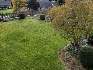 Enjoy the tranquility of this stunning property, featuring a lush green lawn perfect for relaxation.