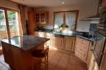 This stunning kitchen boasts a spacious island with a granite countertop, perfect for meal preparation and casual dining.