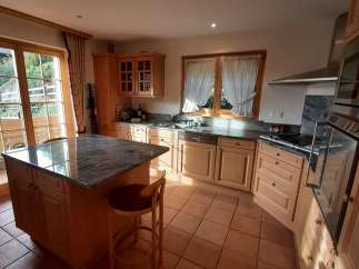 This stunning kitchen boasts a spacious island with a granite countertop, perfect for meal preparation and casual dining.