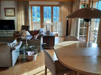Experience the warmth of this inviting living space, featuring a stunning wooden ceiling and floors that create a cozy atmosphere.