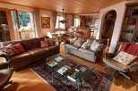 Step into a cozy living space with a warm wooden ceiling and inviting leather sofas.