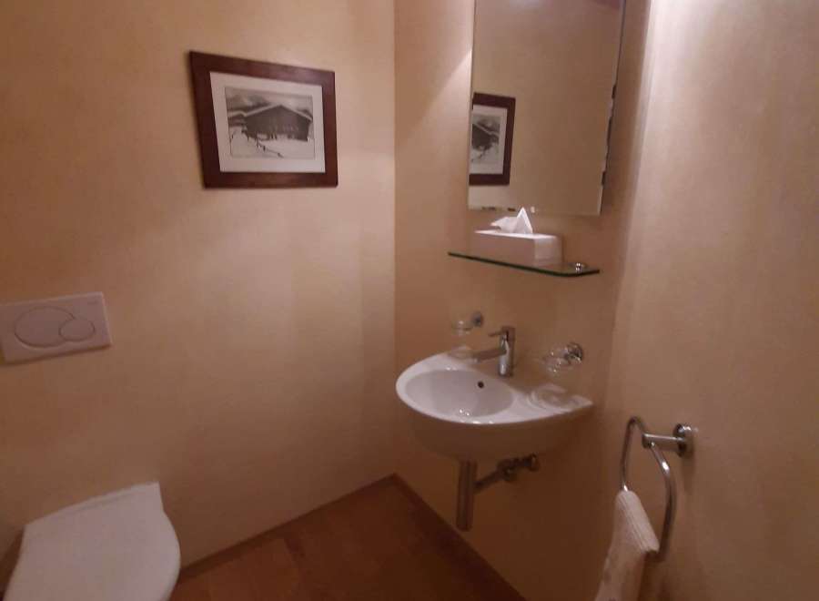 This cozy powder room features a charming aesthetic with warm, inviting tones.