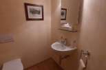 This cozy powder room features a charming aesthetic with warm, inviting tones.