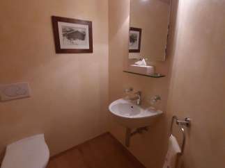 This cozy powder room features a charming aesthetic with warm, inviting tones.