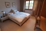 Cozy bedroom with a comfortable double bed, perfect for a relaxing stay.