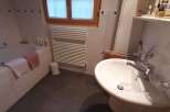 This charming bathroom features a bright and airy atmosphere with a large window that lets in plenty of natural light.