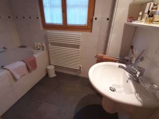This charming bathroom features a bright and airy atmosphere with a large window that lets in plenty of natural light.