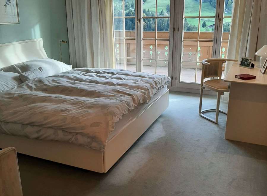 Experience the tranquility of this bedroom with stunning mountain views.