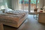Experience the tranquility of this bedroom with stunning mountain views.