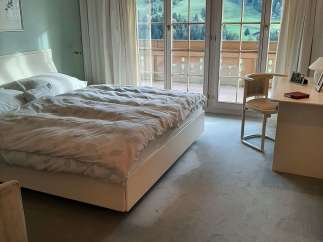 Experience the tranquility of this bedroom with stunning mountain views.
