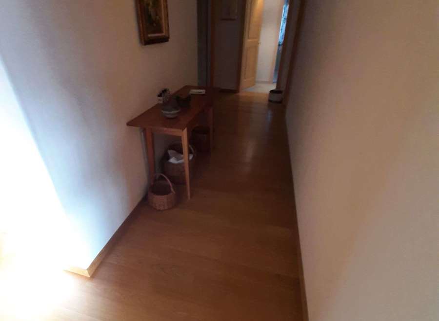 Explore the inviting hallway with warm wooden flooring.