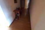 Explore the inviting hallway with warm wooden flooring.
