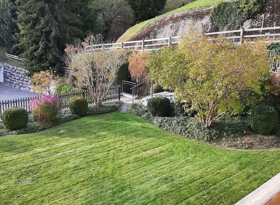 Enjoy the serene beauty of this property, featuring a lush green lawn and meticulously landscaped gardens.