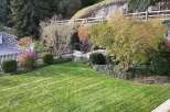 Enjoy the serene beauty of this property, featuring a lush green lawn and meticulously landscaped gardens.