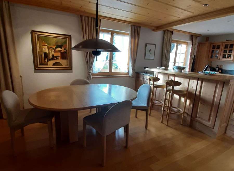 This charming dining area features a beautiful wooden ceiling and a stylish pendant light.