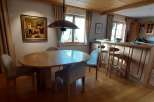 This charming dining area features a beautiful wooden ceiling and a stylish pendant light.
