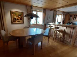 This charming dining area features a beautiful wooden ceiling and a stylish pendant light.
