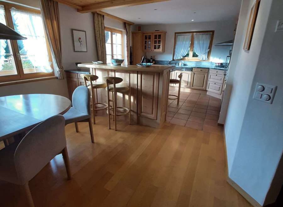 This charming kitchen boasts a warm and inviting atmosphere with its wooden ceiling and flooring.