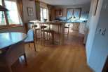This charming kitchen boasts a warm and inviting atmosphere with its wooden ceiling and flooring.