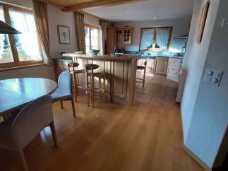 This charming kitchen boasts a warm and inviting atmosphere with its wooden ceiling and flooring.