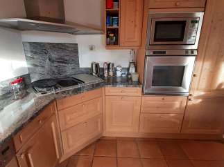 This stunning kitchen boasts a modern design with sleek stainless steel appliances.