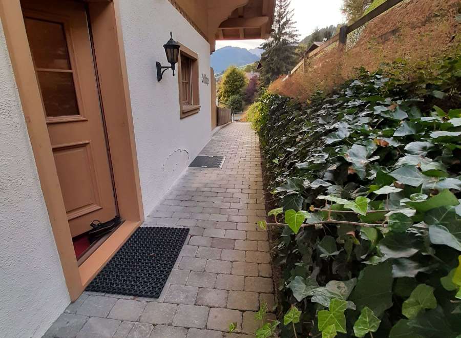Discover the charm of this property with its inviting entrance and well-maintained pathway.