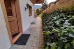 Discover the charm of this property with its inviting entrance and well-maintained pathway.