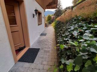 Discover the charm of this property with its inviting entrance and well-maintained pathway.