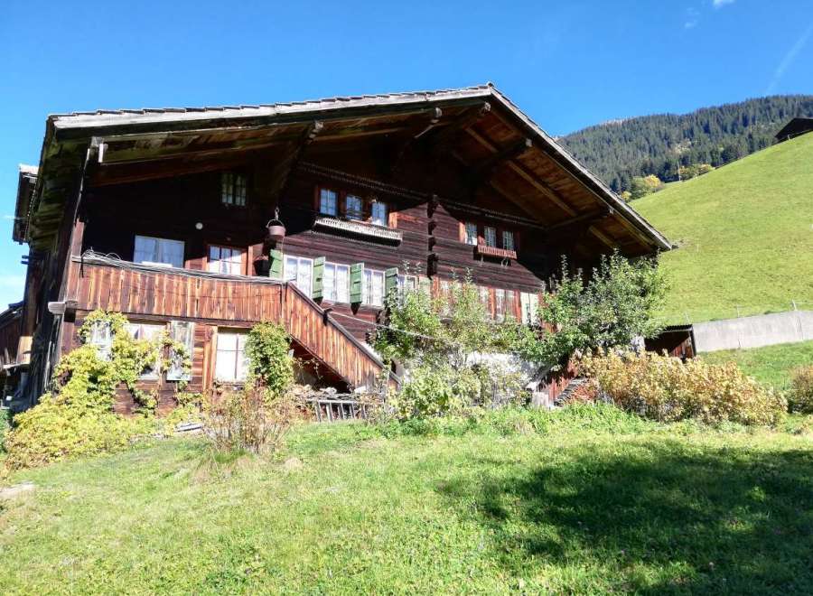 Nestled in a picturesque landscape, this charming wooden house exudes rustic elegance.