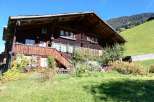 Nestled in a picturesque landscape, this charming wooden house exudes rustic elegance.