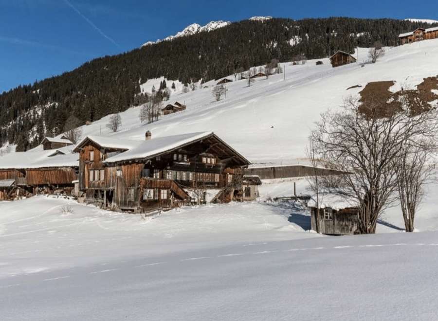 Nestled in a snowy landscape, this charming wooden property offers a serene escape.