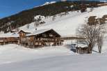 Nestled in a snowy landscape, this charming wooden property offers a serene escape.