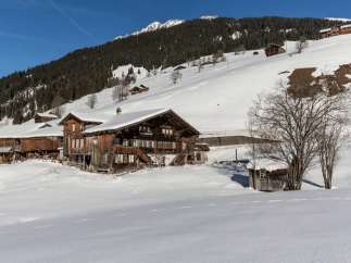 Nestled in a snowy landscape, this charming wooden property offers a serene escape.