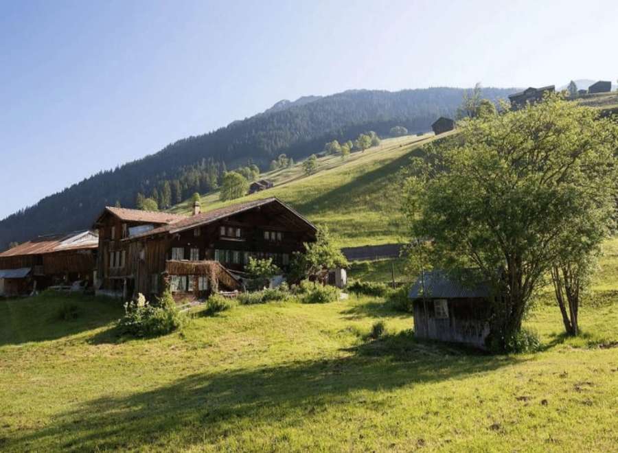 Discover a charming wooden house nestled in a picturesque mountain landscape.