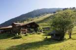 Discover a charming wooden house nestled in a picturesque mountain landscape.