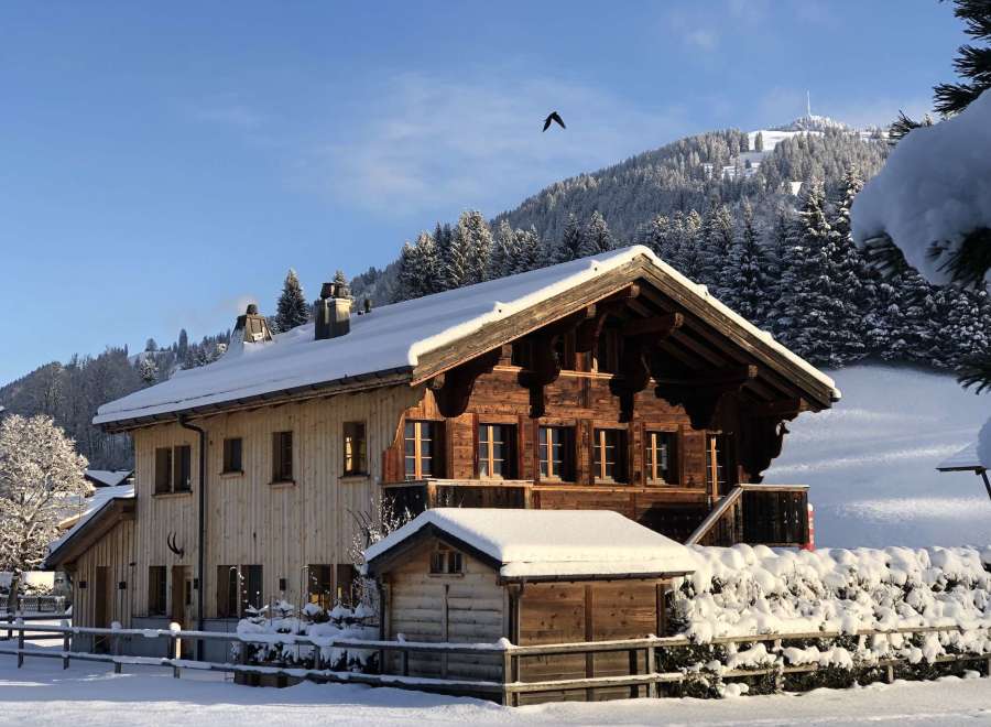 Experience the charm of a snow-covered chalet nestled in the mountains.