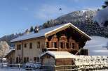 Experience the charm of a snow-covered chalet nestled in the mountains.