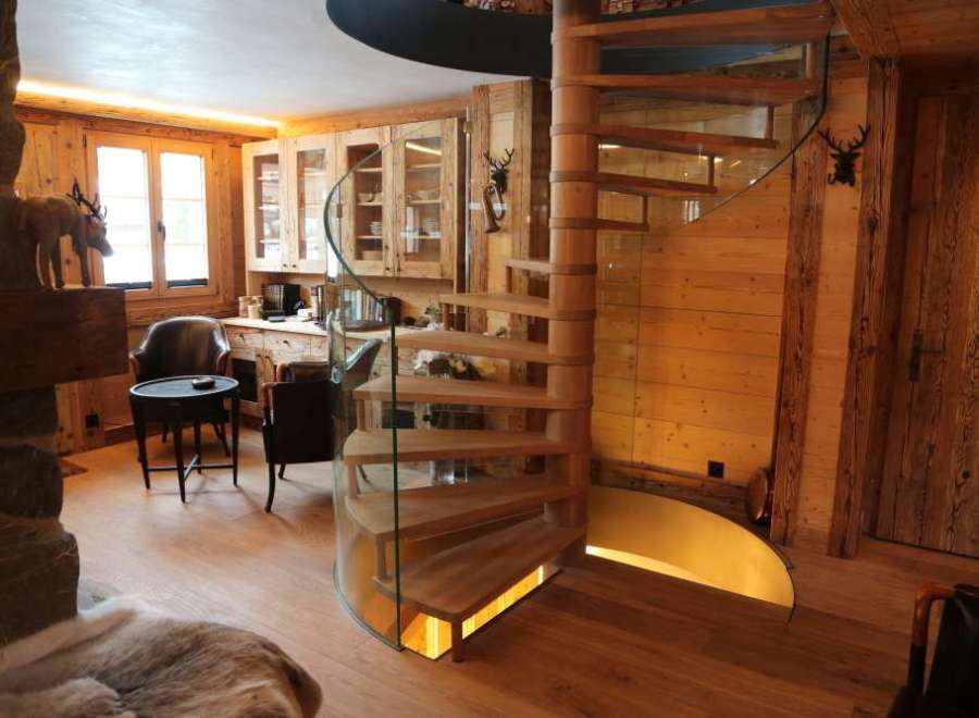 Experience rustic elegance in this stunning property, featuring a beautiful wooden spiral staircase.