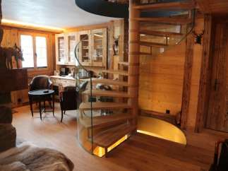 Experience rustic elegance in this stunning property, featuring a beautiful wooden spiral staircase.
