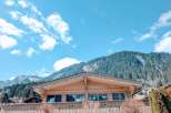 Escape to the mountains in this charming wooden chalet, offering stunning views of the surrounding peaks.