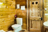 This cozy bathroom features beautiful wooden paneling, creating a warm and inviting atmosphere.