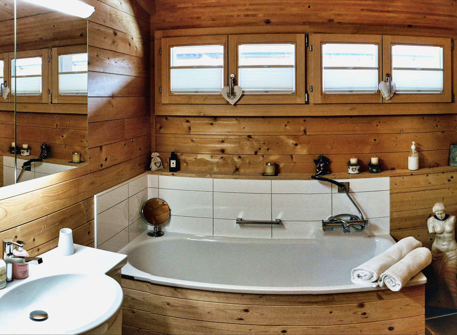 Step into a rustic bathroom retreat, where natural wood paneling creates a warm and inviting atmosphere.