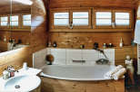 Step into a rustic bathroom retreat, where natural wood paneling creates a warm and inviting atmosphere.