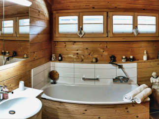 Step into a rustic bathroom retreat, where natural wood paneling creates a warm and inviting atmosphere.
