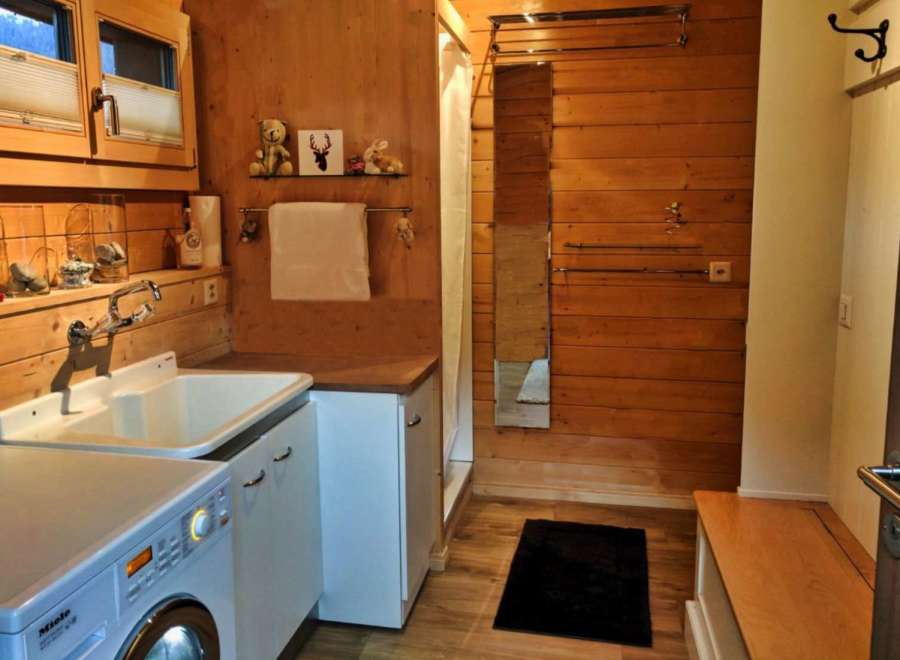 This cozy bathroom features a rustic wooden design, creating a warm and inviting atmosphere.