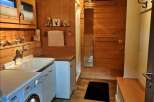 This cozy bathroom features a rustic wooden design, creating a warm and inviting atmosphere.